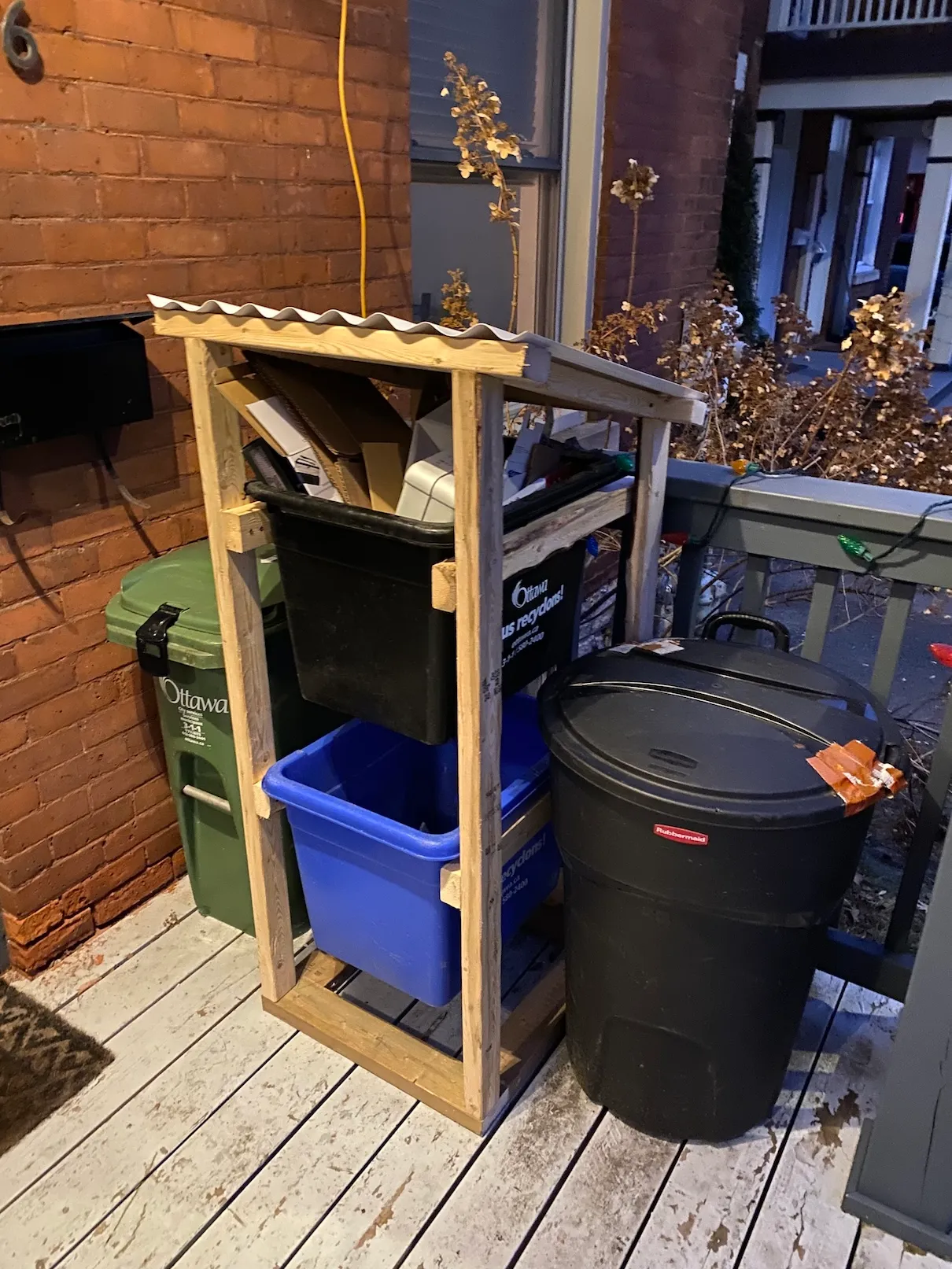 Finished wooden recycling tower on a front porch